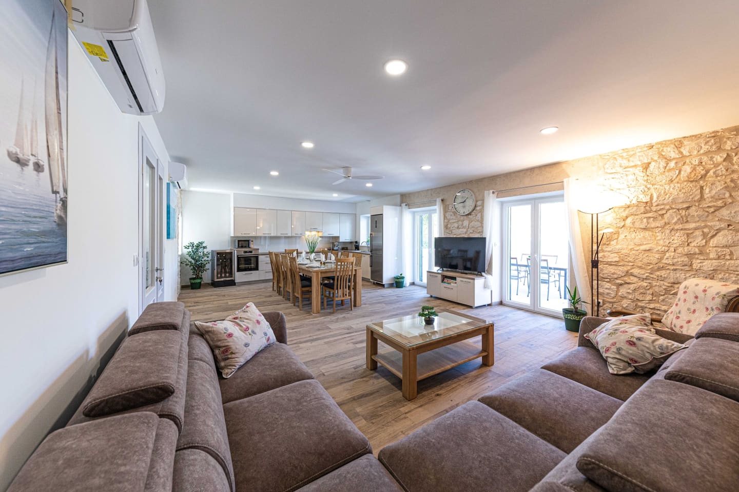 Living room with exposed stone wall and sofas